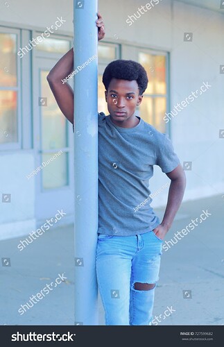 stock-photo-young-man-model-leaning-on-pole-in-the-street-727599682