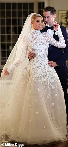 50409923-10193829-One_Paris_looked_sensation_in_three_separate_bridal_outfits_for_-a-231_1636775958065