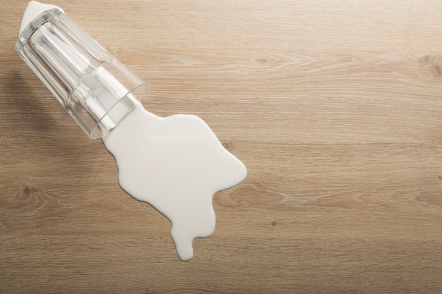 wooden-floor-with-overturned-glass-white-milk_90380-2260